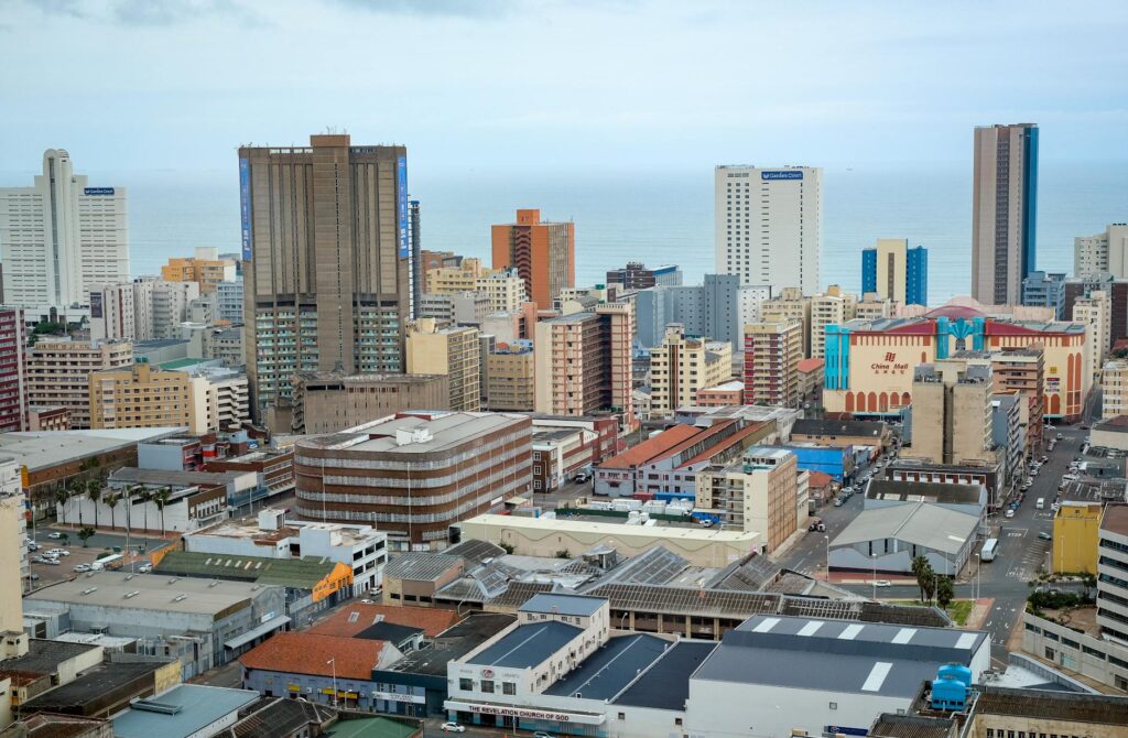 Panoramic view of Durban's modern skyline showcasing high-rise buildings and ocean backdrop.