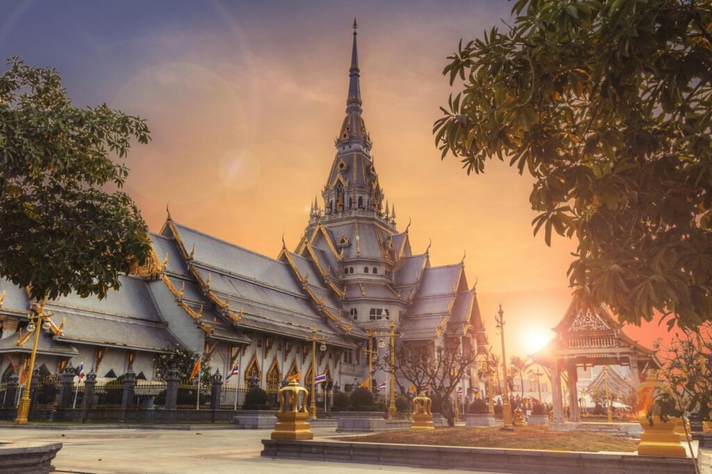 Scenic view of Wat Sothonwararam Temple during sunset in Thailand, capturing its beautiful architecture.