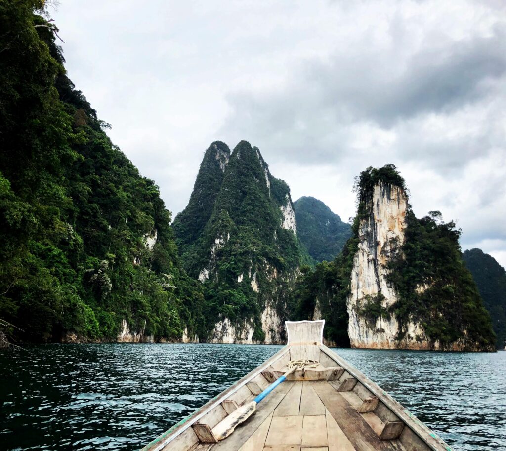 Experience the breathtaking scenery of Khao Sok's limestone cliffs on a serene boat ride.