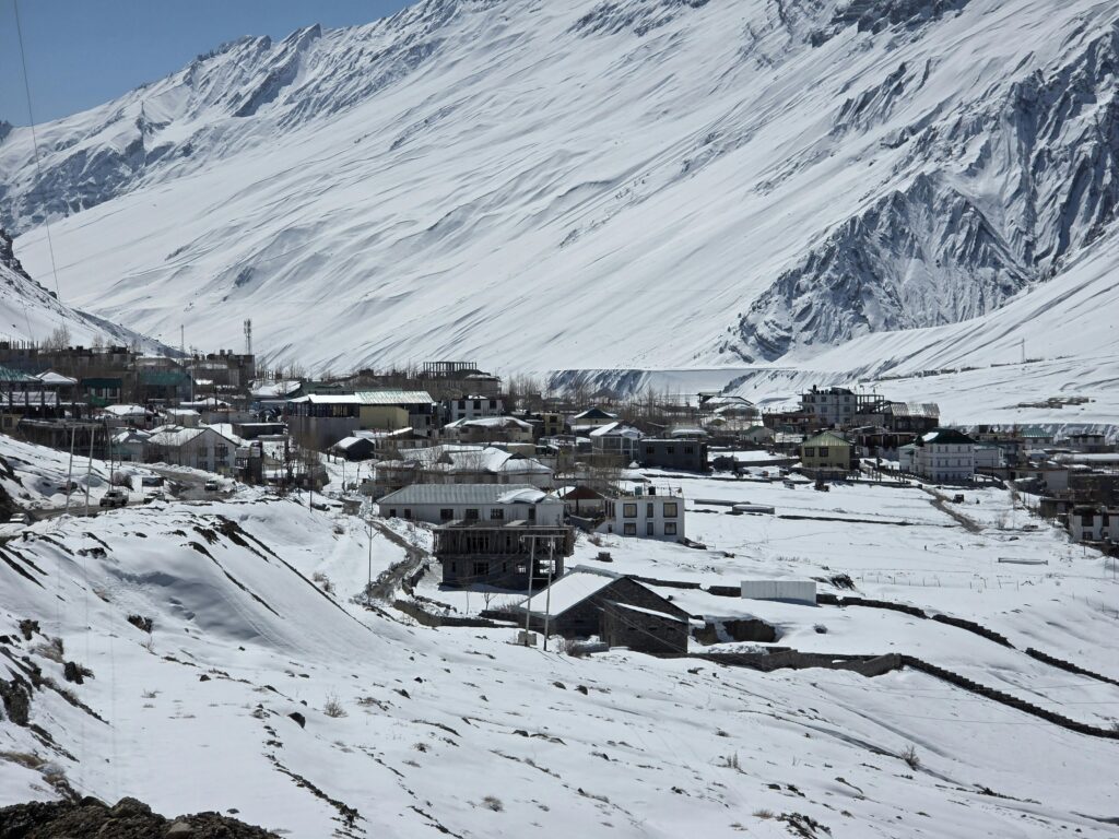 Quaint village in snow-covered Spiti Valley, Himachal Pradesh, offering stunning winter landscape views.