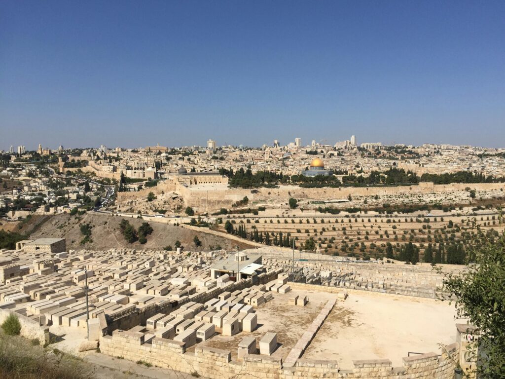 Stunning view of Jerusalem featuring the iconic Dome of the Rock under a clear blue sky.